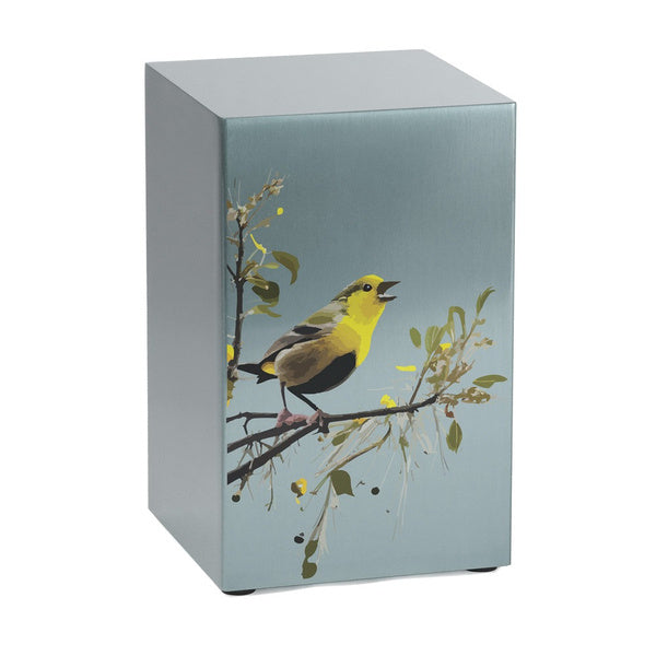 Life Canvas Birds Pewter Companion Urn – Left Side View. A rectangular stainless-steel cremation urn with a brushed pewter finish, featuring an artistic illustration of a yellow and black songbird perched on a delicate tree branch. Designed for individual use or as part of a companion urn set. Can be personalized. Secure bottom panel closure with four screws. 200 cubic inch capacity.