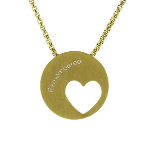 The Bronze Eternity Heart Memorial Necklace, available at Magnolia Cremations, is a modern gold-tone stainless steel pendant featuring an off-centered heart cutout. Designed to hold a small portion of ashes, this piece offers a subtle yet meaningful tribute to a loved one. The pendant is paired with a matching 21-inch chain and includes an engraving option for personalization.