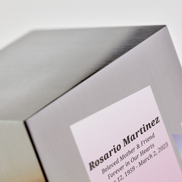 Close-up of the Life Canvas Butterflies Pewter Full-Size Cremation Urn, highlighting its brushed silver stainless-steel finish and soft pink gradient panel. Engraving is available for personalization. 200 cubic inch capacity.