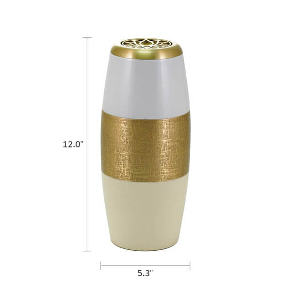 A scattering urn with a modern, tapered cylindrical design, shown with dimensions labeled: 12.0 inches in height and 5.3 inches in width. The urn features a white upper section, a gold-textured middle band, and a cream-colored lower section. The gold lid on top displays a decorative lotus flower cutout.