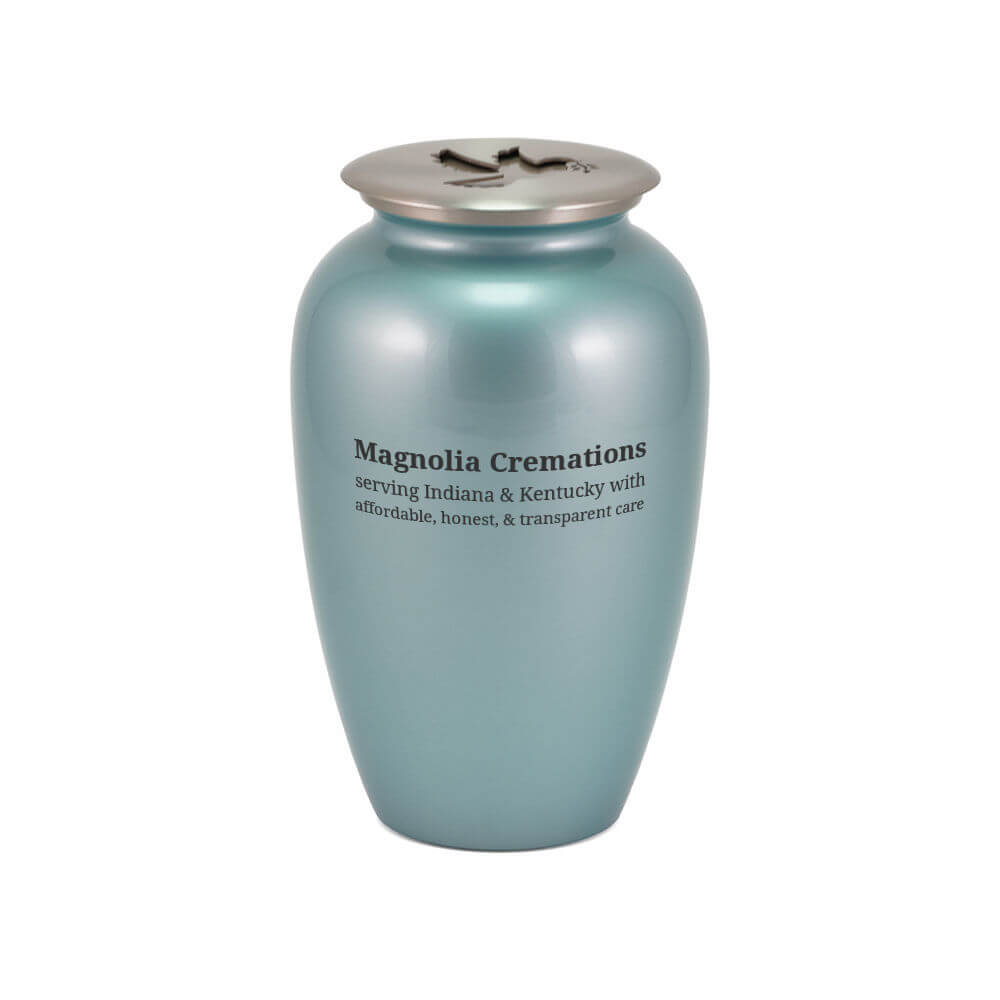 Light blue scattering urn with a silver-toned lid featuring a dove cutout. The front of the urn is printed with the text: "Magnolia Cremations – serving Indiana & Kentucky with affordable, honest, & transparent care."
