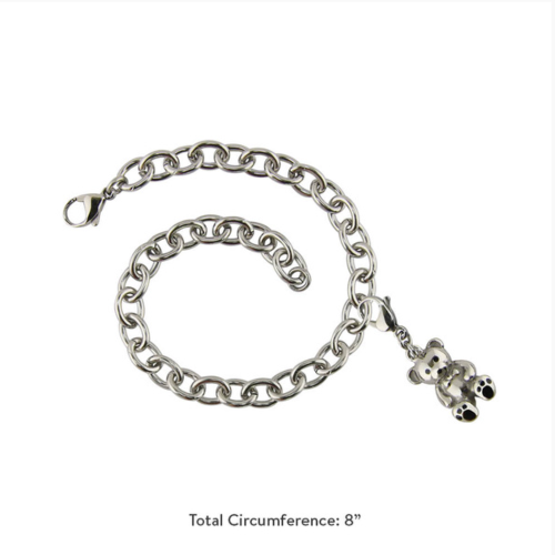 The Charm Bracelet with Teddy Bear Charm, available at Magnolia Cremations, is an elegant stainless steel bracelet featuring a petite teddy bear charm with black paw print details. Designed to discreetly hold a small portion of ashes, this sentimental keepsake offers a comforting way to keep a loved one close. The bracelet has a total circumference of 8 inches and includes a secure lobster clasp.