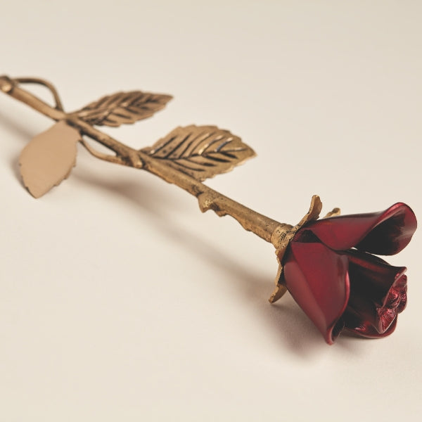 The Crimson Rose Keepsake, available at Magnolia Cremations, is a beautifully crafted brass memorial piece featuring a deep red rose with a detailed golden stem and textured leaves. Designed to hold a small portion of ashes, this elegant tribute serves as a lasting symbol of love and remembrance.