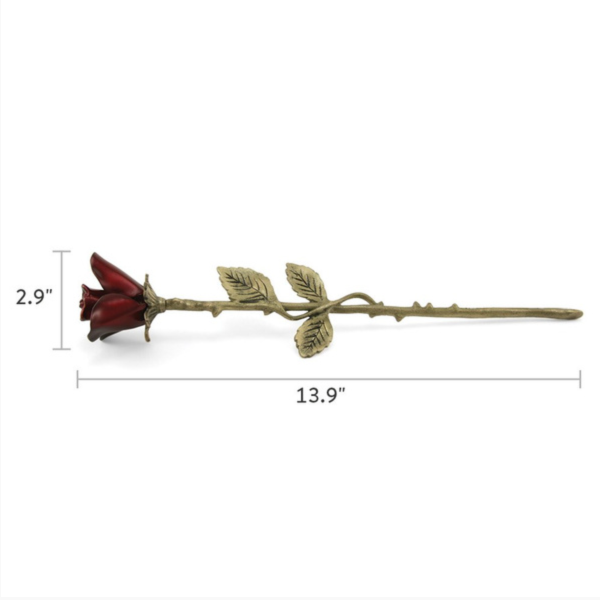 The Crimson Rose Keepsake is a brass memorial piece with a deep red flower and a gold-tone stem featuring detailed leaves and thorns. Measuring 13.9 inches in length and 2.9 inches in height, this elegant keepsake holds a nominal amount of ashes, offering a lasting tribute to a loved one.