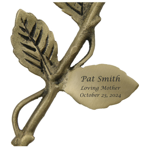 The Crimson Rose Keepsake, available at Magnolia Cremations, features a brass stem with detailed leaves and engraving is shown. This elegant memorial piece is designed to hold a small portion of ashes, serving as a lasting tribute to a loved one.