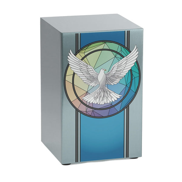 A contemporary stainless steel urn with a brushed pewter finish, featuring a vibrant stained glass-inspired design of a white dove in flight. The geometric background blends shades of blue, green, and purple, creating a peaceful and artistic tribute.