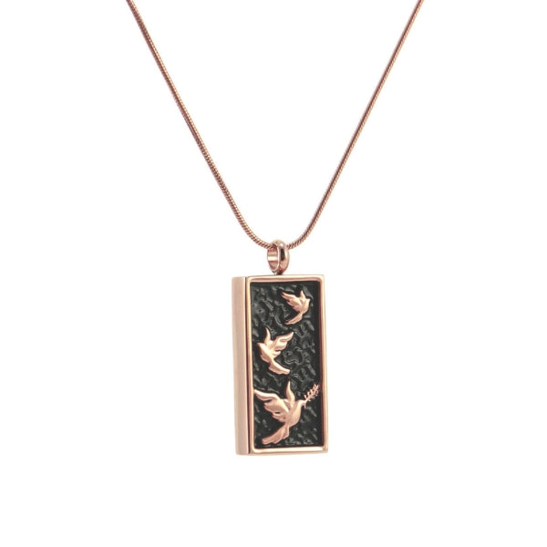 The Embossed Rose/Onyx Doves Memorial Necklace, available at Magnolia Cremations, is a stainless steel pendant featuring a rose gold-tone frame and embossed doves over a textured black background. Designed to hold a small portion of ashes, this piece provides a meaningful way to keep a loved one close. The pendant comes with a matching 19-inch chain and offers an engraving option for personalization.