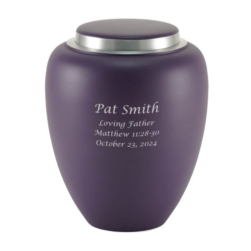 A matte amethyst-colored memorial urn with a silver-toned lid. The urn features engraving, which is available for personalization.