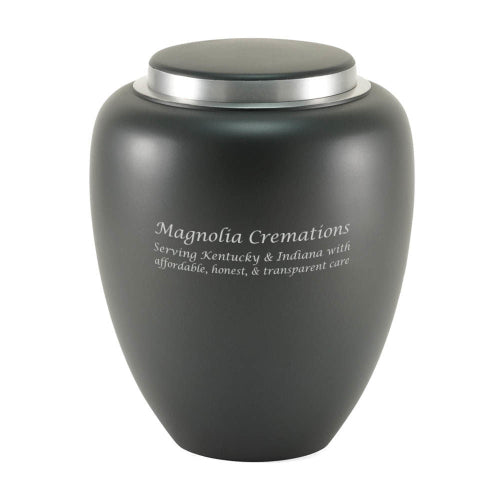 A matte granite gray memorial urn with a silver lid, featuring engraved text on the front. The urn has a smooth, modern design and is suitable for personalization. Engraving is shown and available.