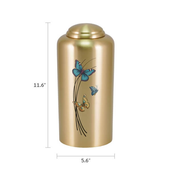 Gold-colored cremation urn with a domed lid, measuring 11.6 inches tall and 5.6 inches wide. The urn is decorated with three colorful butterflies—blue, orange, and teal—flying around black curved lines on the front.
