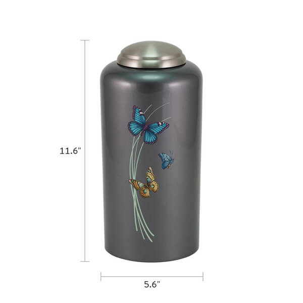 Dark gray cremation urn with a metallic finish and domed silver lid, measuring 11.6 inches tall and 5.6 inches wide. The front features a design of three colorful butterflies—blue, teal, and orange—fluttering around pale green curved lines.