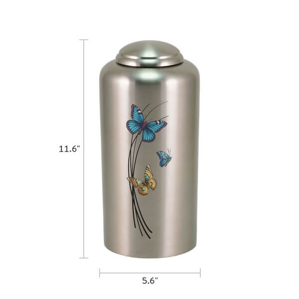 Silver-colored cremation urn with a domed lid, measuring 11.6 inches tall and 5.6 inches wide. The urn is decorated with three colorful butterflies—blue, teal, and orange—fluttering around black curved lines on the front.
