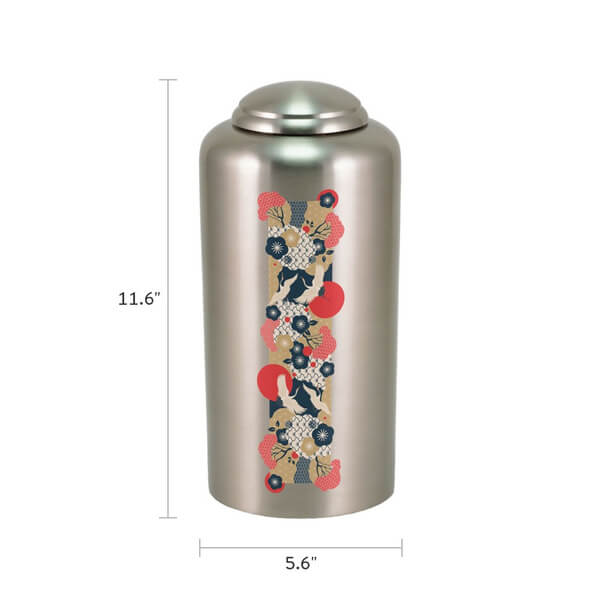 Silver cremation urn with Japanese-style crane and floral design in red, navy, cream, and gold, shown with dimensions. The urn is 11.6 inches tall and 5.6 inches wide.