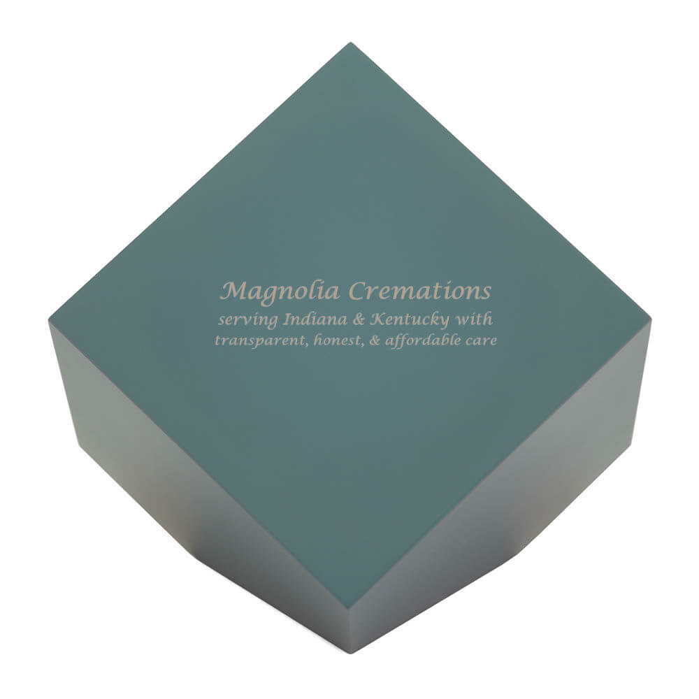 Sage green cremation urn with a modern geometric shape. Optional engraving is shown on one side.