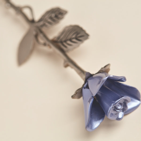 The Lavender Rose Keepsake, available at Magnolia Cremations, is a beautifully crafted brass memorial piece featuring a soft lavender rose with a detailed pewter-finished stem and textured leaves. Designed to hold a small portion of ashes, this elegant tribute serves as a lasting symbol of love and remembrance.