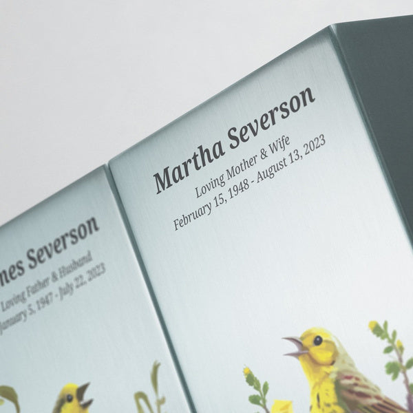 Companion urn with a serene bird scene. The Life Canvas Birds Pewter urn (right side) features a detailed depiction of birds in flight, creating a sense of peace and remembrance. This full-size urn is made from brushed stainless steel and is designed to be paired with the matching left-side urn.