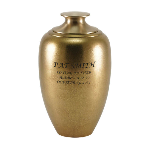 Luna Textured Bronze Memorial Urn with custom engraving displayed on its elegant, golden surface. The gently curved shape and subtle textured finish create a refined and timeless tribute to a loved one. Personalization available.
