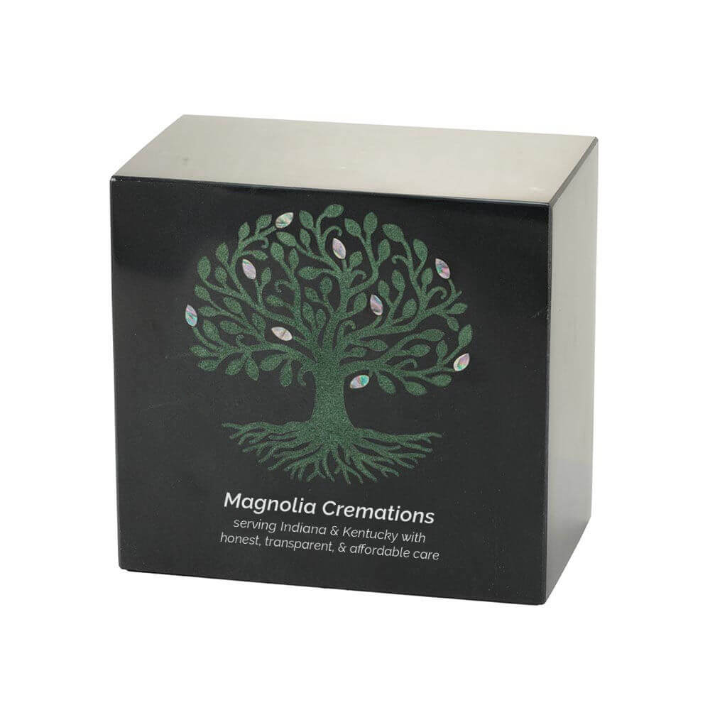 Black marble cremation urn with a decorative green tree inlay featuring swirling branches, roots, and iridescent leaf-shaped accents; optional engraving is shown.