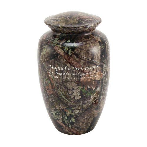 Magnolia Cremations Mossy Oak Camo Memorial Urn, a full-size aluminum urn designed for outdoor enthusiasts. Featuring an authentic Mossy Oak Break-Up Country camouflage pattern, this urn reflects a deep love for nature, hunting, or the great outdoors. Engraving is shown as an available option for a personalized tribute.