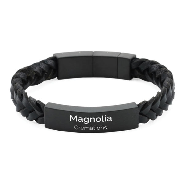 The Onyx/Black Braided Leather Bracelet, available at Magnolia Cremations, is a stylish and durable memorial piece featuring a black braided leather band and a sleek stainless steel plate. This discreet cremation bracelet includes a secure compartment for holding a small portion of ashes and offers an engraving option for personalization. Designed for everyday wear, it provides a meaningful way to keep your loved one close.