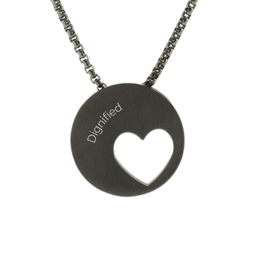 The Onyx Eternity Heart Memorial Necklace, available at Magnolia Cremations, is a sleek black stainless steel pendant featuring a modern off-centered heart cutout. Designed to hold a small portion of ashes, this elegant piece provides a meaningful way to honor a loved one. The pendant includes a matching 21-inch chain and offers an engraving option for personalization.