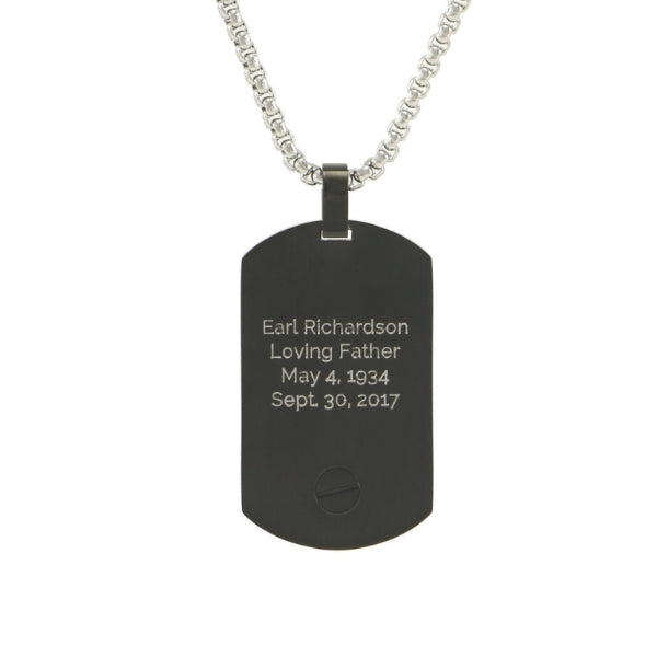The Onyx Pendant Tag Necklace, available at Magnolia Cremations, features a sleek black stainless steel design with a discreet compartment for holding a small portion of ashes. The back of the pendant includes an engraving option for personalization. This meaningful piece comes with a matching 24-inch chain.