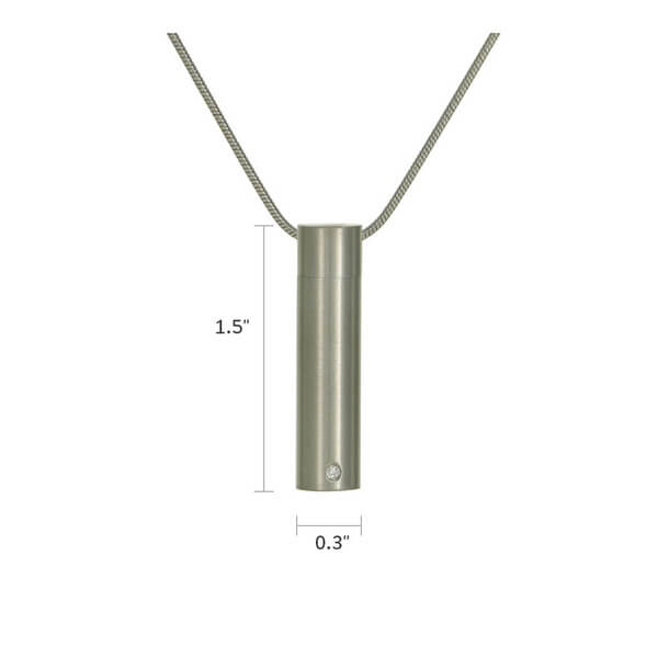 The Pewter Cylinder Memorial Necklace, available at Magnolia Cremations, is a sleek stainless steel pendant measuring 1.5 inches in height and 0.3 inches in width. Designed for subtle remembrance, it features a cubic zirconia accent for a touch of elegance. This modern cylindrical pendant discreetly holds a nominal amount of ashes, allowing you to keep a loved one close. A matching chain is included, and engraving options are available for personalization.
