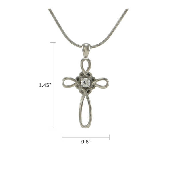 The Pewter Infinity Cross Memorial Necklace, available at Magnolia Cremations, is a delicate stainless steel pendant featuring an infinity cross design with graceful loops and a central cubic zirconia accent. Measuring 1.45 inches in height and 0.8 inches in width, this elegant piece includes a discreet compartment for holding a nominal amount of ashes, offering a meaningful way to keep a loved one close. It comes with a matching 19-inch chain.