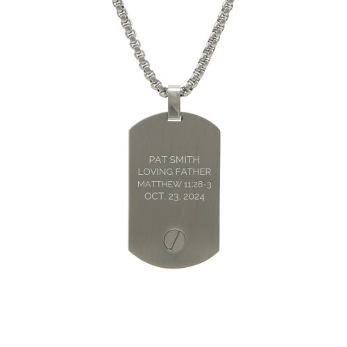 The Pewter Tag Pendant Necklace, available at Magnolia Cremations, is shown with a sample engraving on its sleek stainless steel surface. This contemporary cremation pendant discreetly holds a small portion of ashes, offering a meaningful way to keep a loved one close. The design allows for personalized engraving and features a secure screw compartment at the bottom. A matching 24-inch chain is included for a distinguished and lasting tribute.