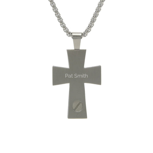 The Pewter Textured Cross Pendant Necklace, available at Magnolia Cremations, is shown here with a personalized engraving on the back. This stainless steel cremation pendant discreetly holds a small portion of ashes, providing a meaningful way to keep a loved one close. Its modern cross design features a subtle texture on the front and a secure screw closure on the back. The pendant includes a matching 24-inch chain and offers engraving options for a personal touch.