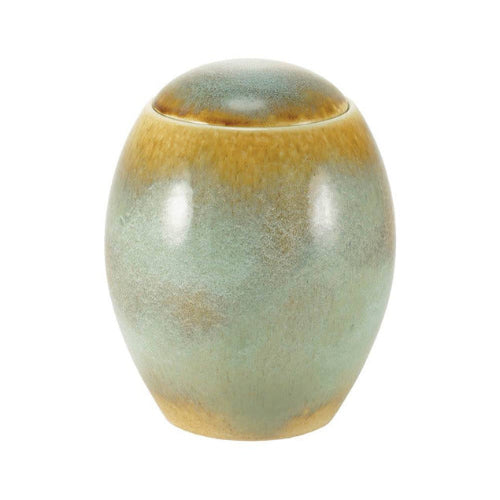 The Serene Reflections Ocean Blue Memorial Urn, available at Magnolia Cremations, is a handcrafted ceramic urn with a smooth, rounded shape. Its glaze features a blend of ocean blue and warm brown tones, creating a natural, flowing pattern. As part of the Serene Reflections Collection, each urn is unique, with no two pieces exactly alike.