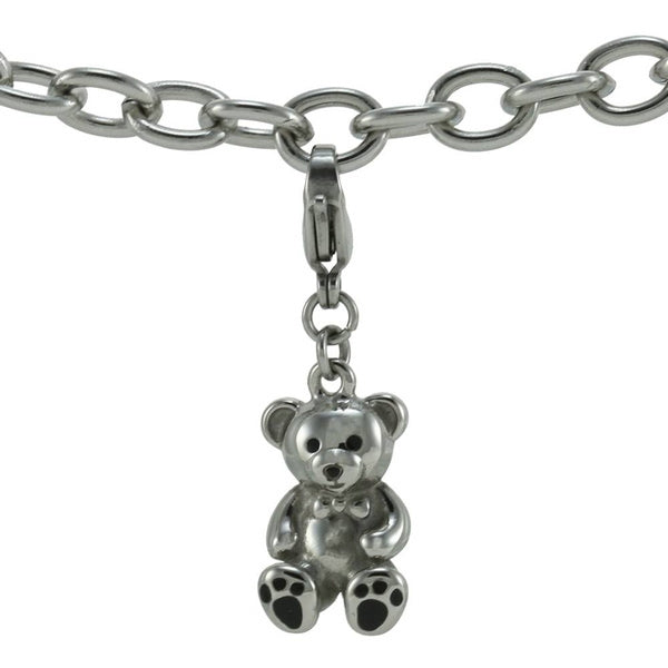 The Teddy Bear Keepsake Charm, available at Magnolia Cremations, is shown attached to a chain bracelet, demonstrating its versatile and wearable design. This stainless steel charm features a polished teddy bear shape with black enamel paw accents and a small bowtie detail, adding a sweet and sentimental touch. The lobster claw clasp allows for easy attachment to bracelets, necklaces, or keychains, making it a portable and discreet way to keep a loved one close.