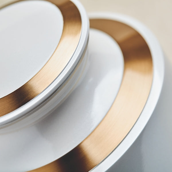 A close-up of the Trinity Pearl Memorial Urn, available at Magnolia Cremations, highlighting its smooth white high-gloss finish and elegant gold accents. The detailed shot focuses on the urn’s lid and upper rim, showcasing the fine craftsmanship and polished brass detailing.