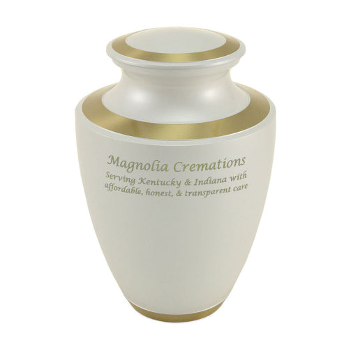 The Trinity Pearl Memorial Urn, available at Magnolia Cremations, showcases a smooth white high-gloss finish with gold accents. The urn is engraved with Magnolia Cremations' branding and message, demonstrating available personalization options. Crafted from brass, this full-size urn provides a timeless and elegant tribute.