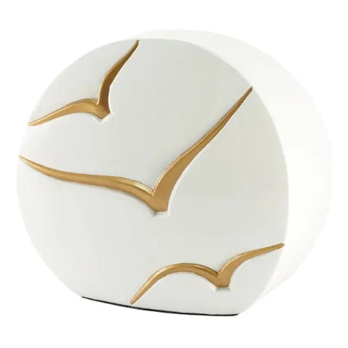 The Windham Going Home Glossy White Memorial Urn, available at Magnolia Cremations, is a modern ceramic urn with a smooth, curved design. Its glossy white surface is adorned with three hand-painted gold birds in flight, symbolizing peace and freedom. The minimalist yet elegant aesthetic makes it a meaningful tribute and a sophisticated addition to any home.