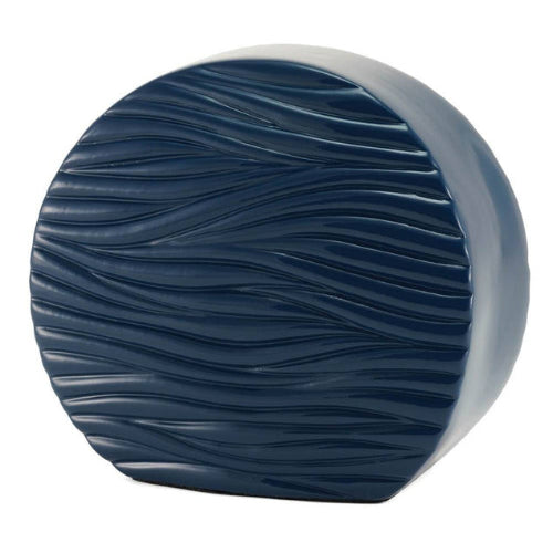 The Windham Soft Waves Glossy Blue Memorial Urn, available at Magnolia Cremations, showcases a striking circular shape with a deep, glossy blue finish. Its surface is adorned with flowing, wave-like textures that evoke a sense of calm and movement. The contemporary design offers a serene and sophisticated tribute, making it a beautiful addition to any home.