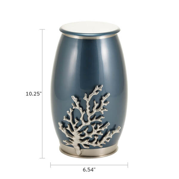 The Windsong Coral Memorial Urn, available at Magnolia Cremations, displayed with dimensions of 10.25 inches in height and 6.54 inches in width. This urn features a deep blue high-gloss finish with a silver-tone stainless steel base and lid. A detailed pewter coral accent is affixed to the front, adding a coastal-inspired element to the design. The urn's smooth, modern silhouette provides an elegant and contemporary tribute.