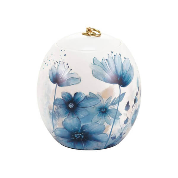 Decorative ceramic memorial cremation urn with blue floral design on a white background