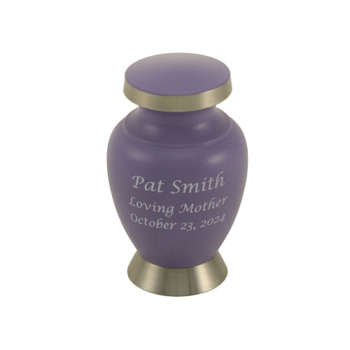 The Aria Butterfly Keepsake Urn from Magnolia Cremations is a small memorial urn designed to hold a portion of a loved one’s ashes, allowing families to share in remembrance. This urn features a soft lavender matte finish, brushed silver trim on the lid and base, and custom engraving on the front. The keepsake size makes it ideal for preserving a meaningful connection to a loved one.