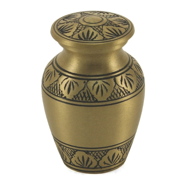 The Athena Bronze Keepsake Urn, available at Magnolia Cremations, is a small, classic urn with a rich bronze finish and intricate black leaf engravings adorning its body and lid. The elegant detailing adds a timeless touch to this traditional design. Engraving is available, offering the option for personalization. Designed to hold a small portion of ashes, this keepsake allows families to cherish a loved one's memory in a shared and meaningful way.