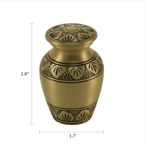 The Athena Bronze Keepsake Urn, available from Magnolia Cremations, is a compact memorial piece featuring a classic bronze finish with detailed black leaf engravings. Measuring 2.8 inches in height, this keepsake urn is designed to hold a small portion of ashes, allowing family members to each keep a meaningful remembrance of their loved one.