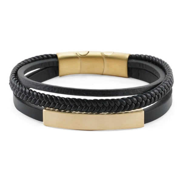 The Brass/Black Triple Band Leather Bracelet, available at Magnolia Cremations, is a modern memorial piece featuring three distinct black leather bands—one smooth, one braided, and one accented with a gold-tone bar. The bracelet secures with a gold-tone stainless steel clasp, offering a sleek and contemporary design. This keepsake jewelry discreetly holds a small portion of ashes, allowing you to keep a loved one close. Personalization is available with optional engraving.