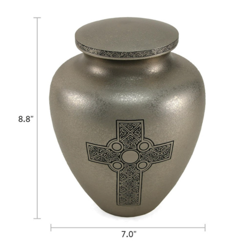 Celtic Cross Full-Size Cremation Urn with dimensions displayed. The urn measures 8.8 inches in height and 7.0 inches in width. Made of brass with a textured silver finish, it features an engraved Celtic Cross design symbolizing faith and eternity. The lid is adorned with an intricate Celtic pattern. 200 cubic inch capacity.