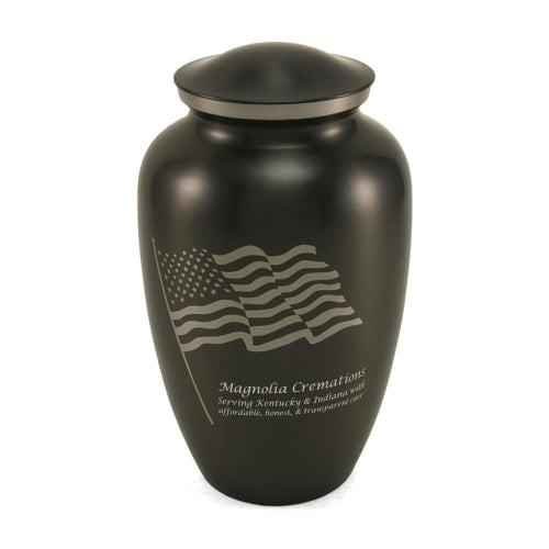 Classic Flag Full-Size Cremation Urn with a black stainless-steel finish. The urn features a silver engraving of the American flag, symbolizing patriotism and honor. Personalization is available with custom engraving. 200 cubic inch capacity.