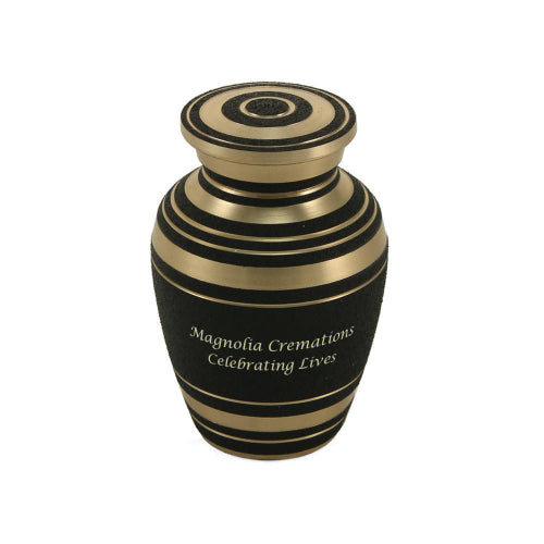 The Elite Onyx Keepsake Urn, available at Magnolia Cremations, features a textured matte black finish with elegant gold-tone bands encircling its body and lid. This classic keepsake urn is designed for personalization, with an engraved message visible on the front. Created to hold a small portion of ashes, it provides a meaningful way for loved ones to share in remembrance.