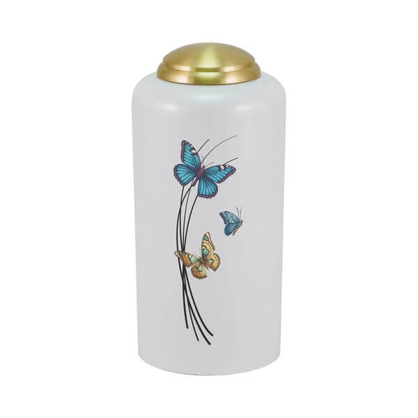 White cremation urn with a gold domed lid, featuring a design of three colorful butterflies—blue, teal, and orange—fluttering around thin black curved lines on the front.