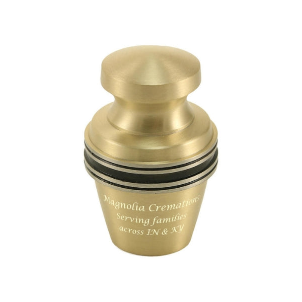 The Grecian Bronze Keepsake Urn, available at Magnolia Cremations, is a small brass urn with a warm gold finish and contrasting black bands. Its sleek, traditional design is enhanced with personalized engraving, offering a meaningful way to honor a loved one. This keepsake urn is designed to hold a small portion of ashes, allowing multiple family members to share in remembrance.