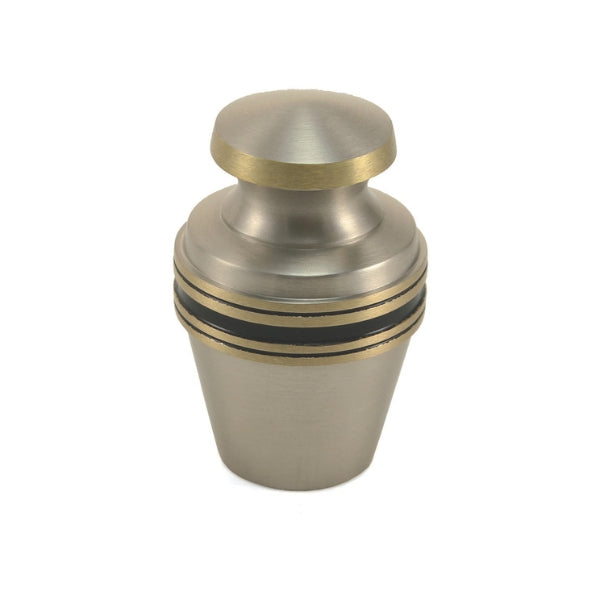 The Grecian Pewter Keepsake Urn, available at Magnolia Cremations, is a small, elegant urn with a brushed silver finish accented by gold and black bands. Its classic design provides a timeless way to honor a loved one's memory. This keepsake urn is crafted from brass and holds a small portion of ashes, making it ideal for sharing among family members. Engraving options are available for personalization.