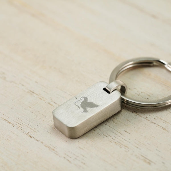 Stainless steel keychain with a dove design, symbolizing peace and remembrance.