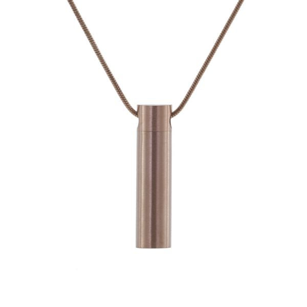 Rose gold cylinder pendant on a chain, for holding ashes.